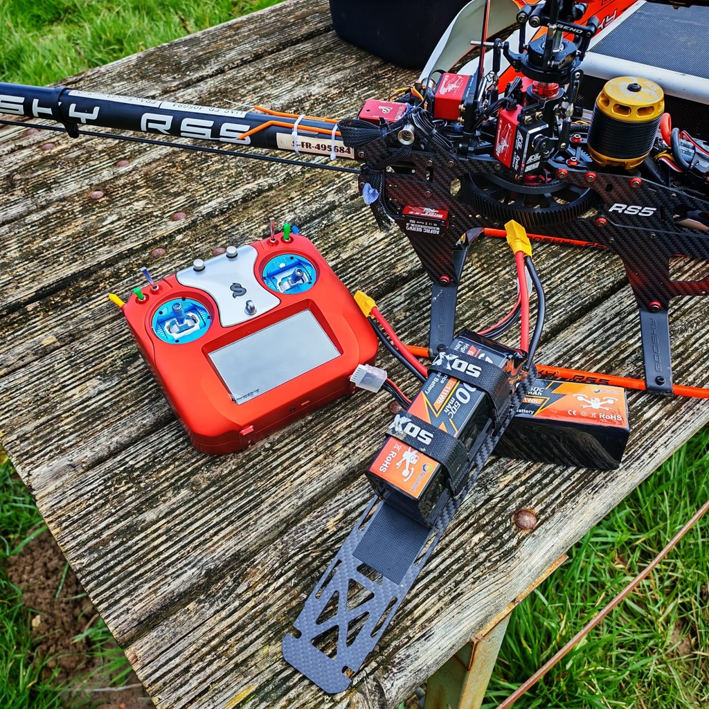 RC helicopter and FPV model LiPo battery on grass field